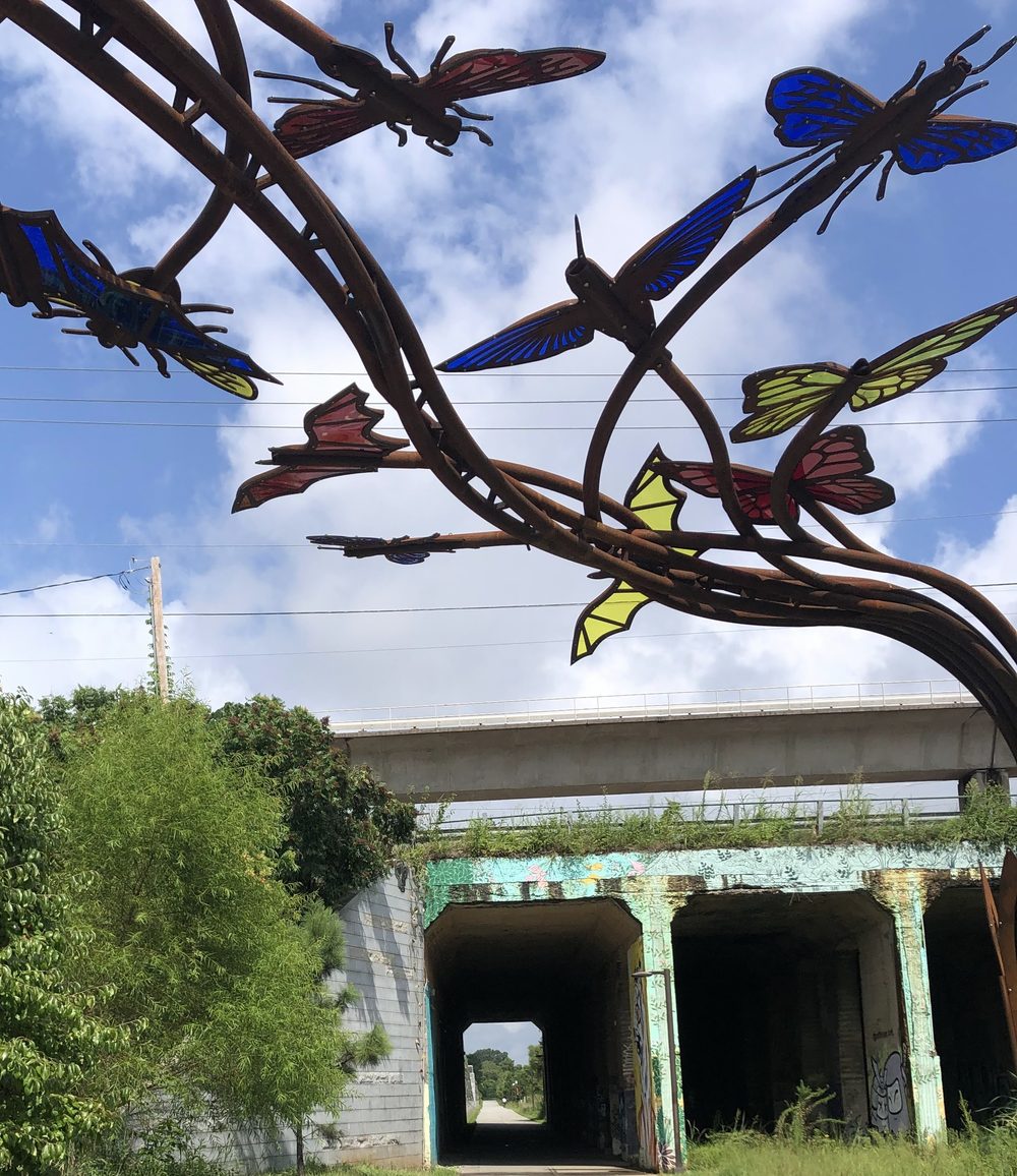 Metal butterfly and dragonfly sculpture at a Beltline underpass
